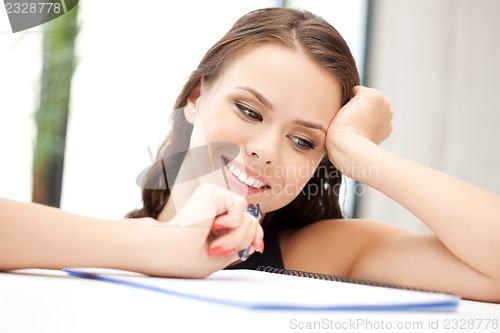 Image of happy woman with big notepad