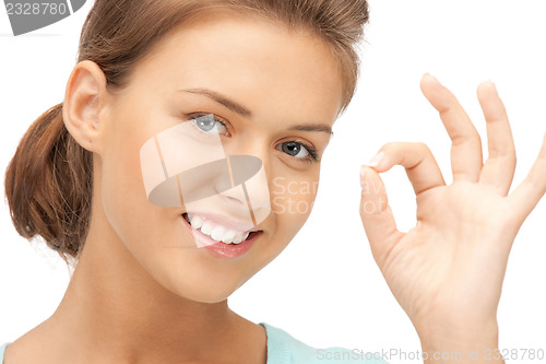 Image of lovely teenage girl showing ok sign