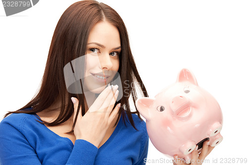 Image of lovely woman with piggy bank