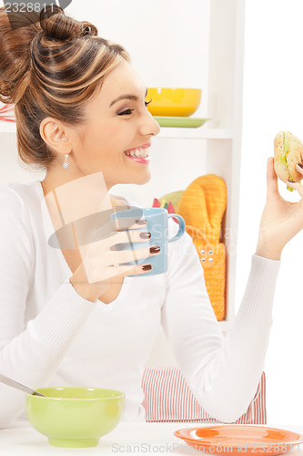 Image of lovely housewife with sandwich