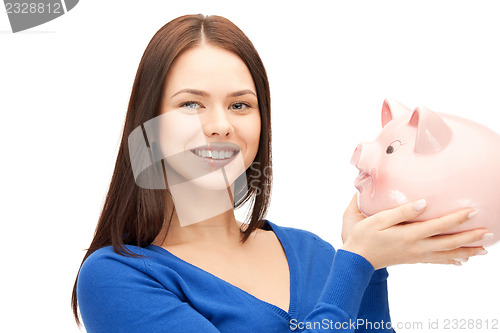 Image of lovely woman with piggy bank