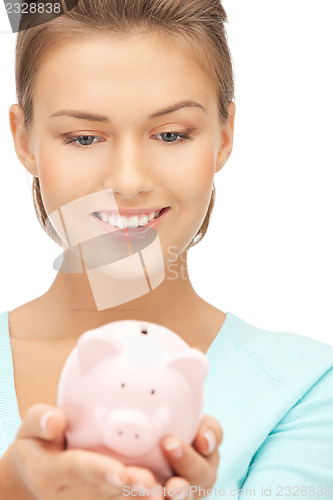 Image of lovely woman with piggy bank