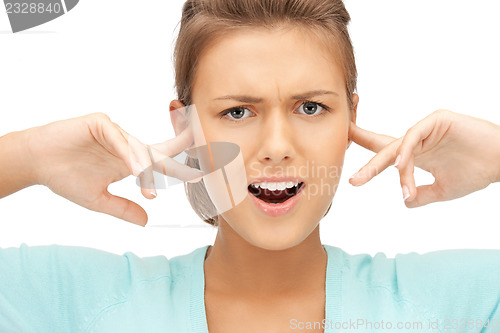 Image of woman with fingers in ears