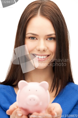 Image of lovely woman with piggy bank