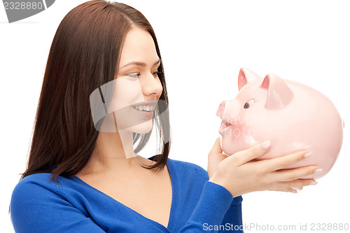 Image of lovely woman with piggy bank