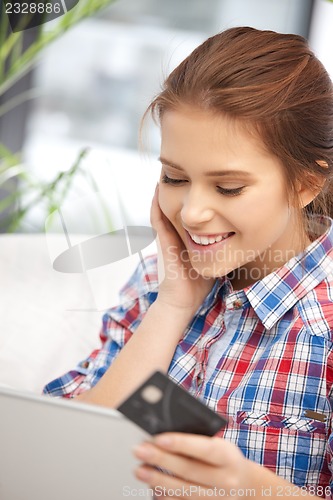 Image of happy woman with laptop computer and credit card