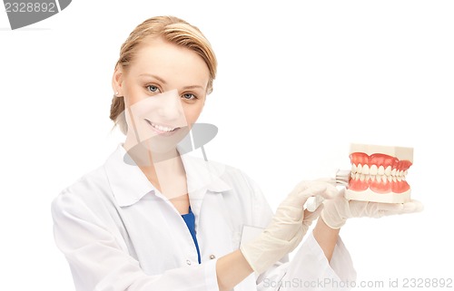 Image of doctor with toothbrush and jaws