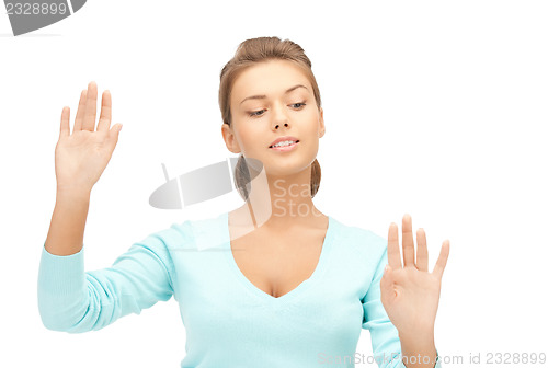 Image of businesswoman working with something imaginary