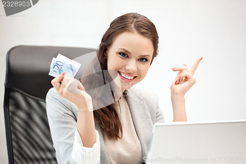 Image of happy woman with computer and euro cash money