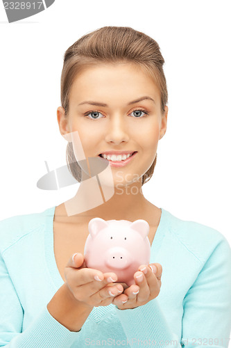 Image of lovely woman with piggy bank