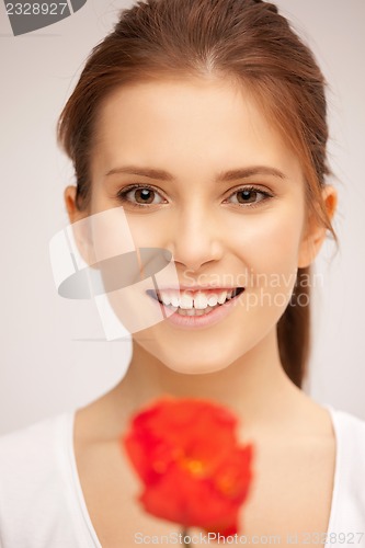 Image of beautiful woman with red flower