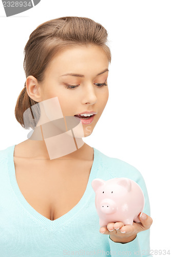 Image of lovely woman with piggy bank