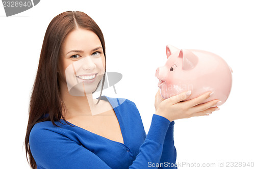 Image of lovely woman with piggy bank