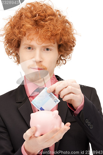 Image of man with piggy bank and money