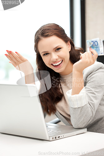 Image of happy woman with computer and euro cash money