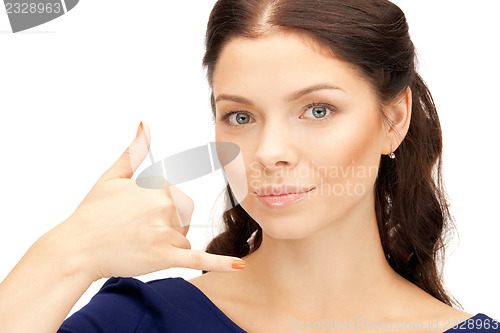 Image of woman making a call me gesture