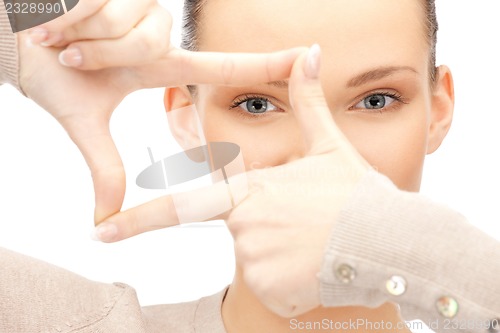 Image of lovely woman creating a frame with fingers