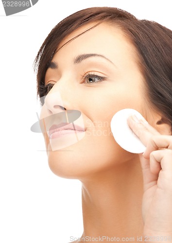 Image of beautiful woman with cotton pad