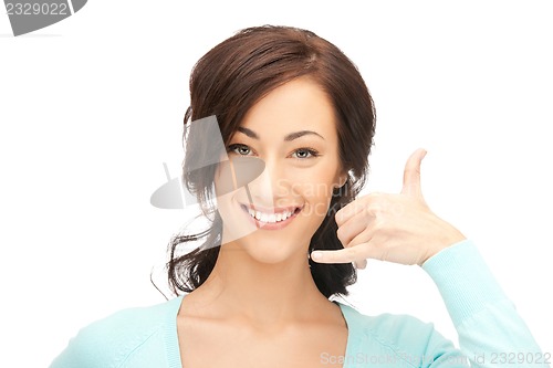 Image of woman making a call me gesture