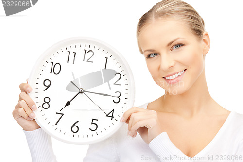 Image of woman holding big clock