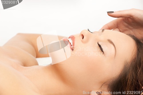 Image of beautiful woman in massage salon