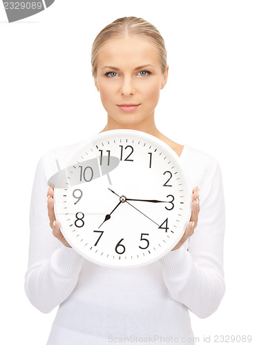 Image of woman holding big clock