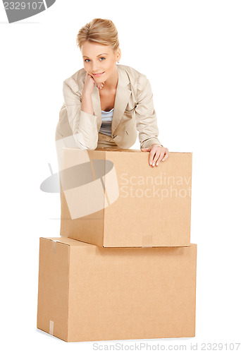 Image of attractive businesswoman with big boxes