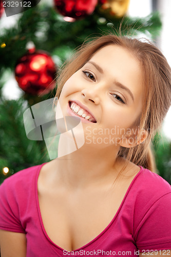 Image of happy and smiling woman with christmas tree