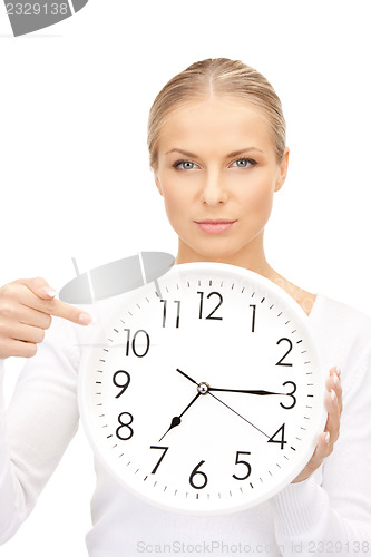 Image of woman holding big clock