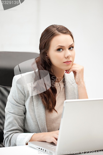 Image of pensive woman with laptop computer