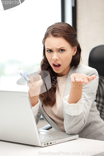 Image of unhappy woman with computer and euro cash money