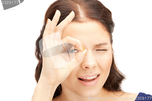 Image of lovely woman looking through hole from fingers