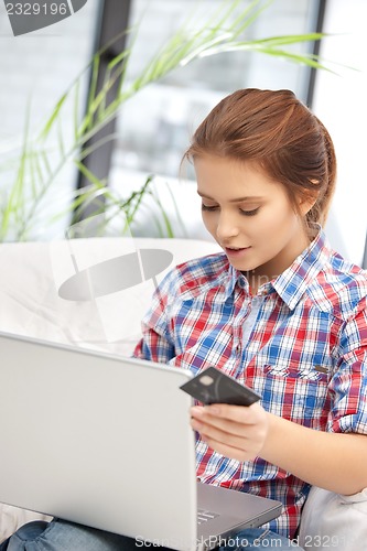 Image of woman with laptop computer and credit card