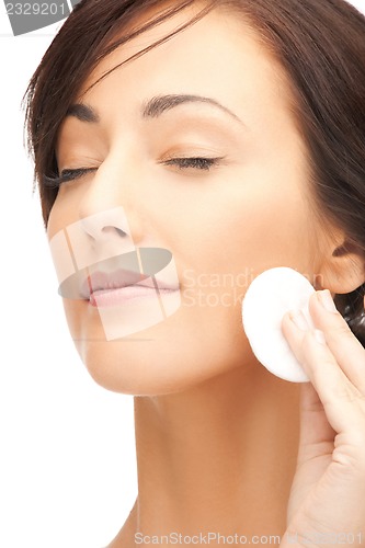 Image of beautiful woman with cotton pad