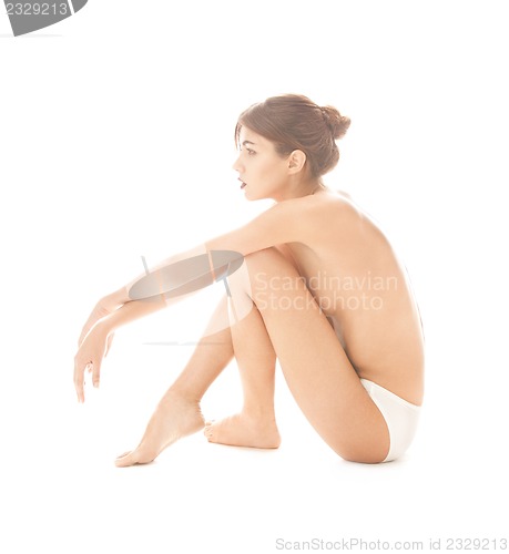 Image of beautiful topless woman in panties