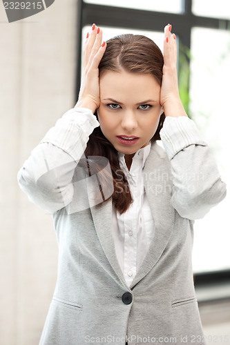 Image of woman with hands on ears
