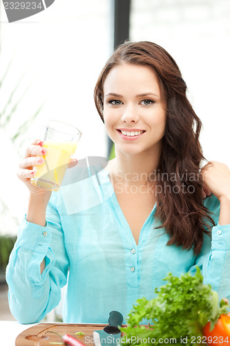 Image of beautiful woman with glass of juice