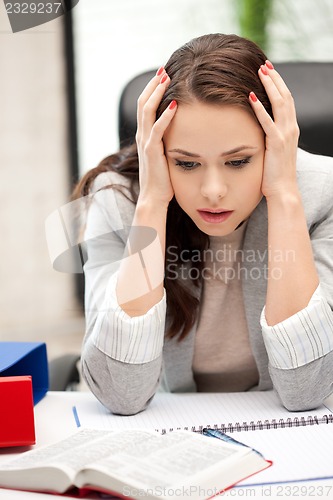 Image of worried woman with book