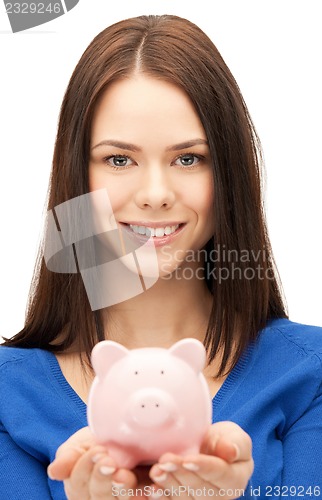 Image of lovely woman with piggy bank