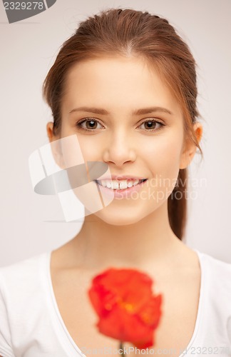 Image of beautiful woman with red flower