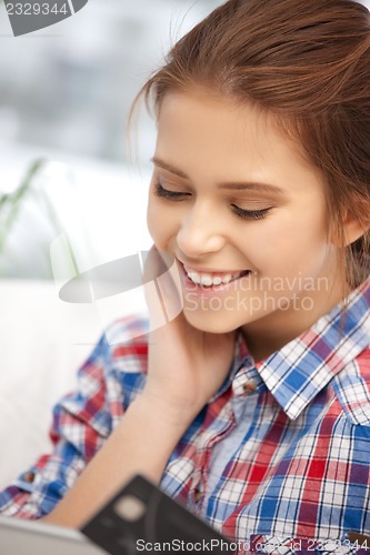 Image of happy woman with laptop computer and credit card