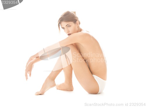 Image of beautiful topless woman in panties