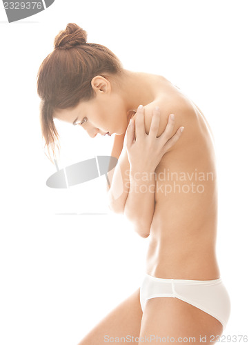 Image of beautiful topless woman in panties