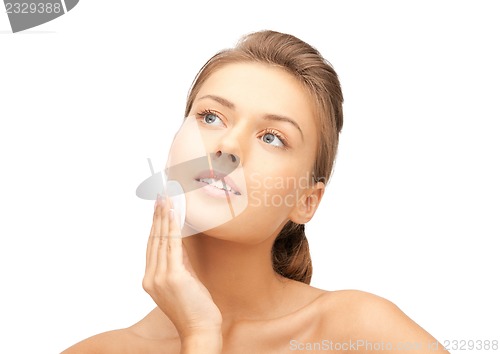 Image of beautiful woman with cotton pad