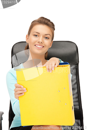 Image of young businesswoman with folders sitting in chair