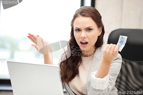 Image of unhappy woman with computer and euro cash money