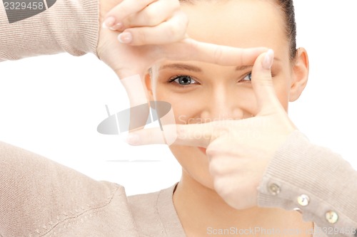 Image of lovely woman creating a frame with fingers