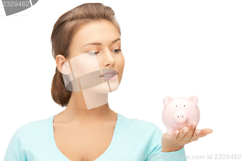 Image of lovely woman with piggy bank