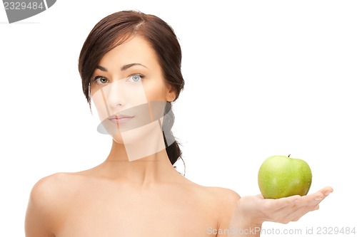 Image of young beautiful woman with green apple