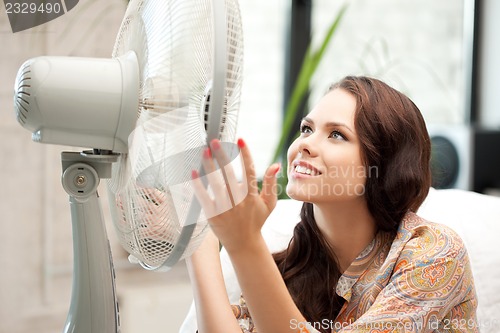 Image of happy woman with big fan